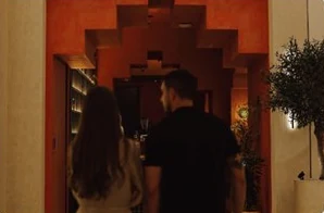 Two guests walking into the terracotta entrance of Shalwa