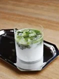 A layered pistachio drink over ice