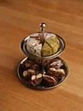A two-tier stand of nuts and small sweets