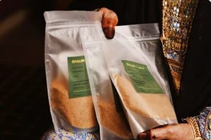 Hands holding clear coffee pouches